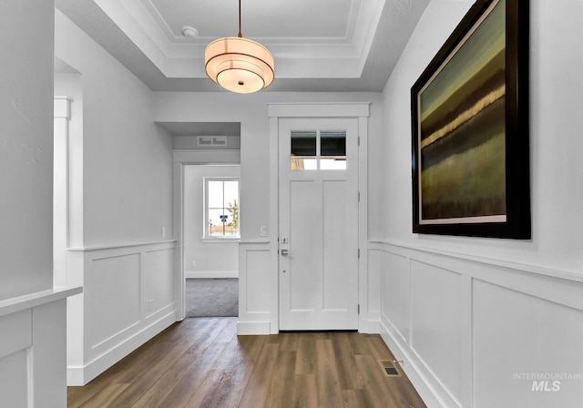 6318 S Utmost Ln, Meridian, ID 83642 - foyer featuring a raised ceiling, dark wood-style flooring, a decorative wall, and wainscoting