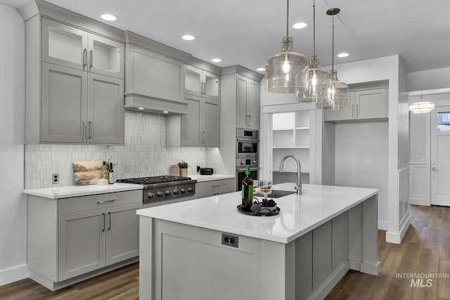 6318 S Utmost Ln, Meridian, ID 83642 - kitchen with stainless steel appliances, gray cabinets, dark wood-type flooring, tasteful backsplash, and light countertops