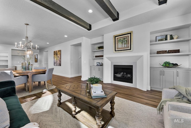 6318 S Utmost Ln, Meridian, ID 83642 - living area with built in features, beamed ceiling, a fireplace, a chandelier, and wood finished floors