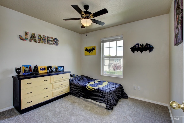 bedroom with baseboards, ceiling fan, a textured ceiling, and carpet flooring