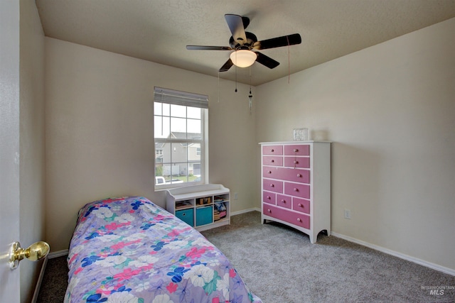 carpeted bedroom featuring a ceiling fan and baseboards