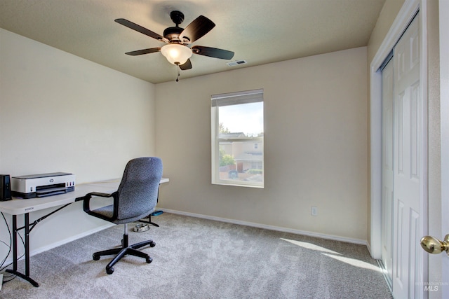 carpeted office with ceiling fan, visible vents, and baseboards