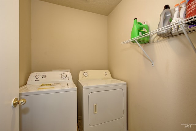 clothes washing area featuring washing machine and clothes dryer and laundry area