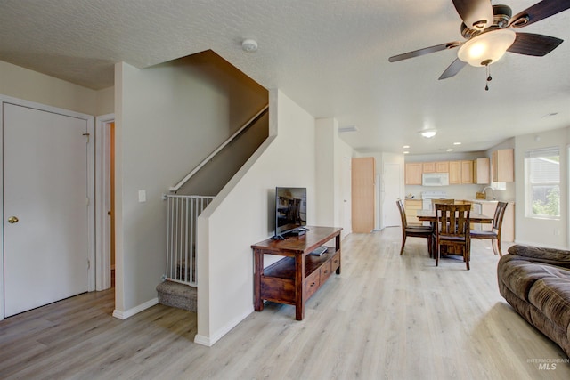 living room with recessed lighting, stairs, baseboards, light wood-type flooring, and a ceiling fan