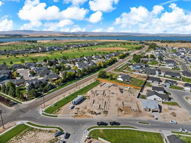 birds eye view of property featuring a water and mountain view