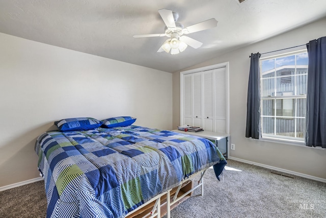 bedroom featuring vaulted ceiling, a closet, carpet, and baseboards