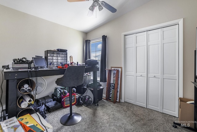 carpeted home office with vaulted ceiling and a ceiling fan