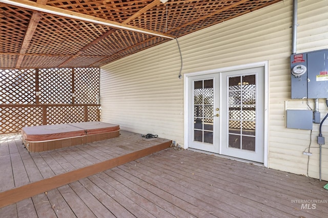 wooden terrace featuring french doors and hot tub deck surround