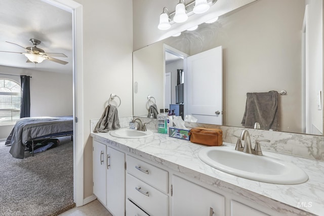 full bath featuring double vanity, ensuite bath, ceiling fan, and a sink