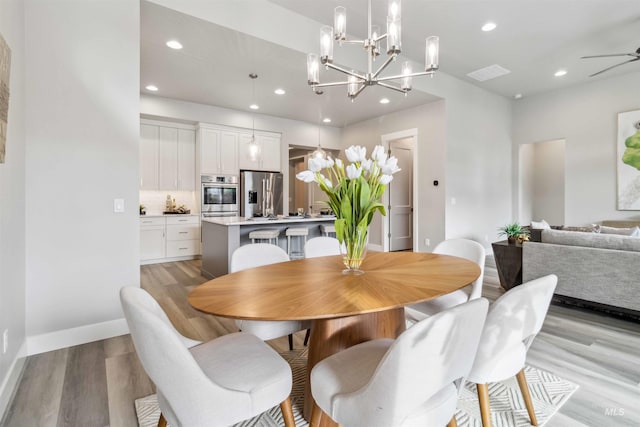 dining space with ceiling fan and light hardwood / wood-style floors