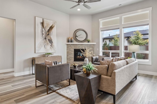 living room featuring wood-type flooring and ceiling fan