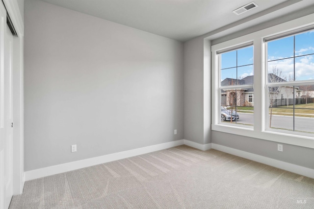 unfurnished room with light colored carpet