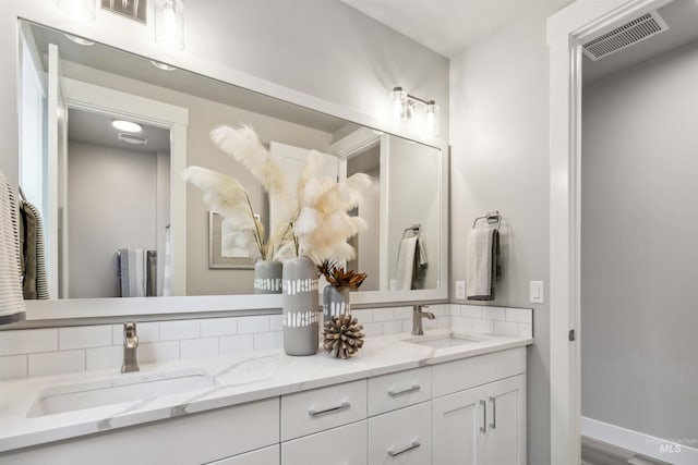 bathroom featuring tasteful backsplash and vanity