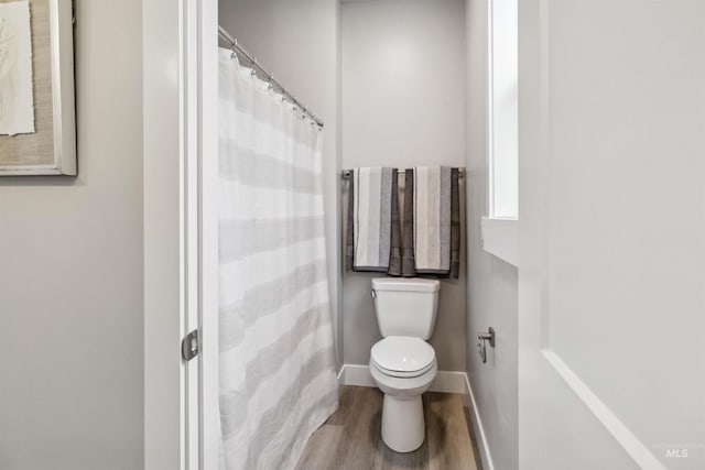 bathroom featuring toilet and hardwood / wood-style floors