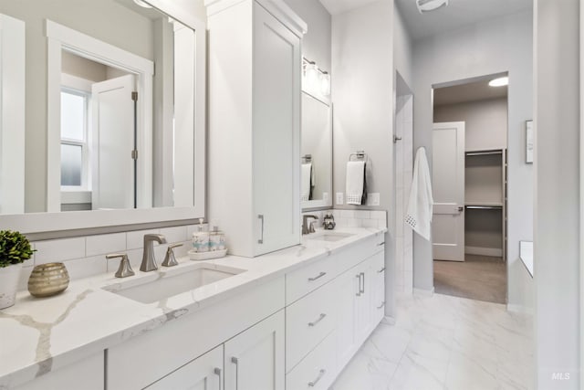 bathroom featuring vanity and decorative backsplash