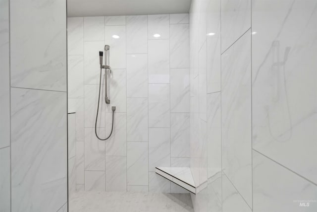 bathroom with tiled shower