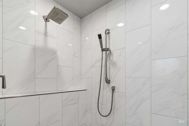 bathroom with a tile shower