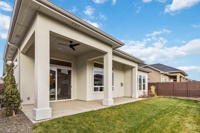 rear view of property featuring a patio, ceiling fan, and a lawn