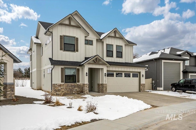 modern farmhouse featuring driveway, a garage, board and batten siding, and stone siding