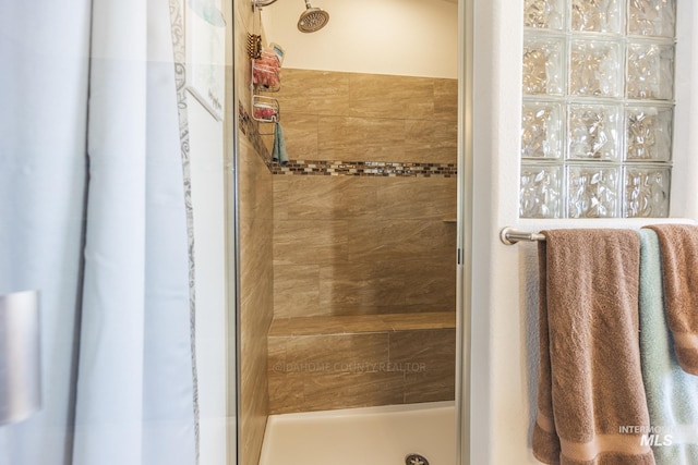 full bath with a tile shower