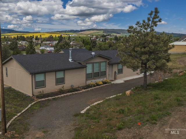 view of front of property featuring roof with shingles