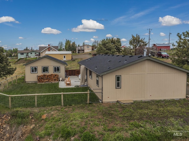 back of house featuring a patio area, a yard, and a fenced backyard