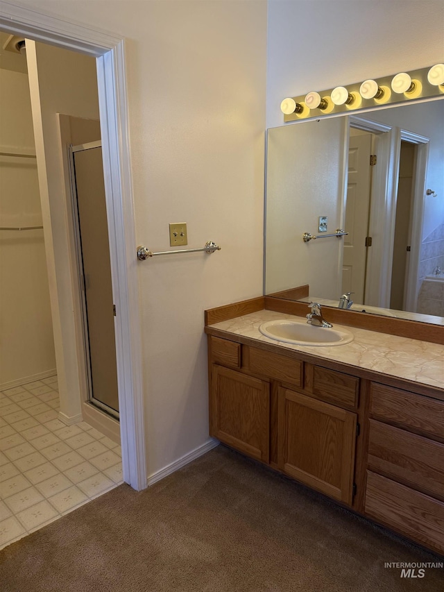 625 Trotter Dr, Twin Falls, ID 83301 - full bathroom featuring carpet floors, a shower stall, vanity, and baseboards