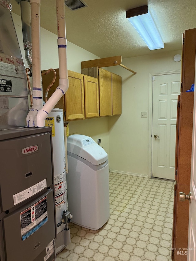 625 Trotter Dr, Twin Falls, ID 83301 - clothes washing area with cabinet space, hookup for an electric dryer, light flooring, a textured ceiling, and water heater