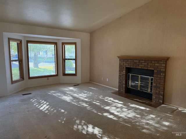 625 Trotter Dr, Twin Falls, ID 83301 - unfurnished living room featuring carpet floors, a brick fireplace, baseboards, and vaulted ceiling