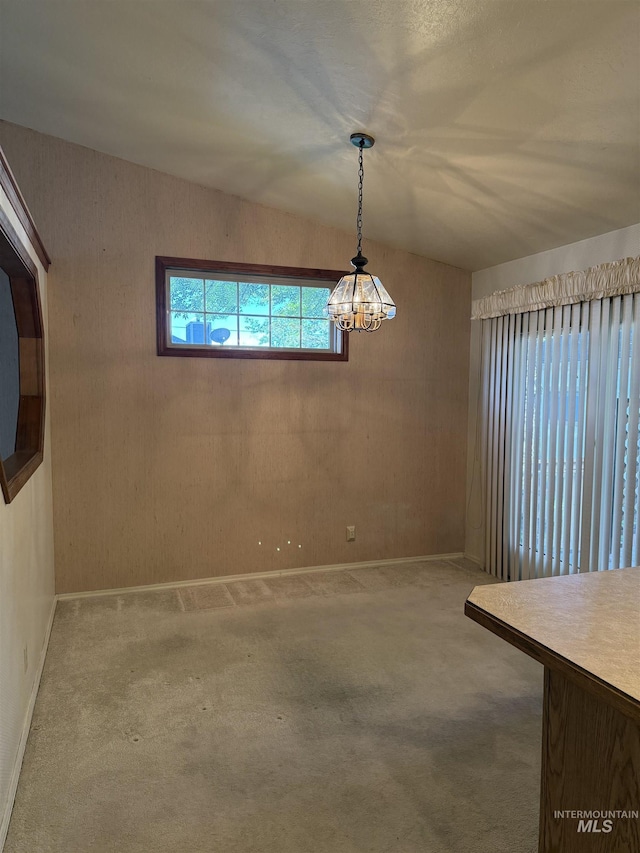 625 Trotter Dr, Twin Falls, ID 83301 - unfurnished dining area with carpet floors, a chandelier, and baseboards