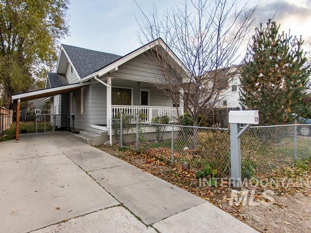 bungalow-style home with a carport and a porch