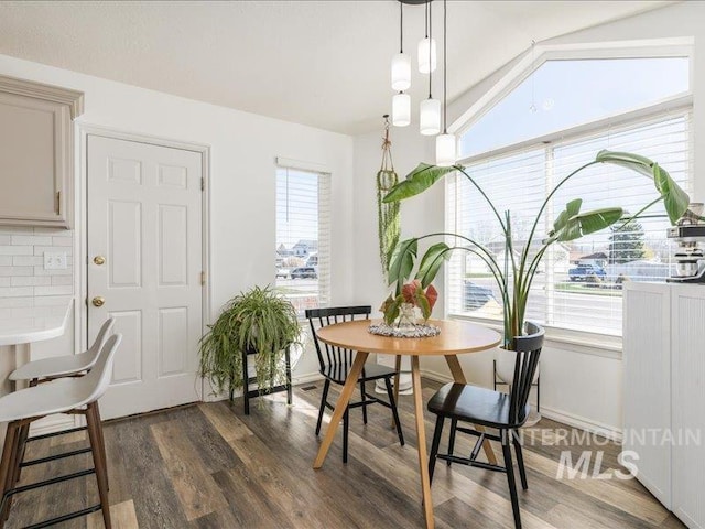 5287 Stuart Ave, Chubbuck, ID 83202 - dining space featuring plenty of natural light, wood finished floors, vaulted ceiling, and baseboards