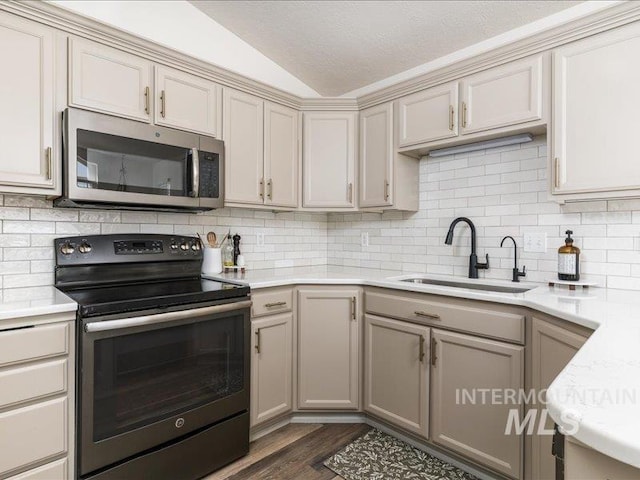 5287 Stuart Ave, Chubbuck, ID 83202 - kitchen featuring stainless steel microwave, electric range oven, a sink, lofted ceiling, and light countertops