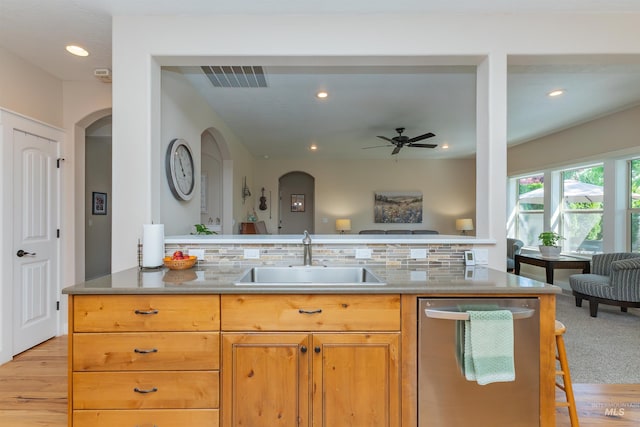 818 W Dallan Woods Way, Nampa, ID 83686 - kitchen with stainless steel dishwasher, arched walkways, open floor plan, recessed lighting, and ceiling fan