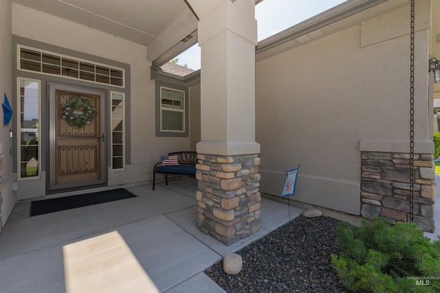 818 W Dallan Woods Way, Nampa, ID 83686 - view of exterior entry with stucco siding and covered porch