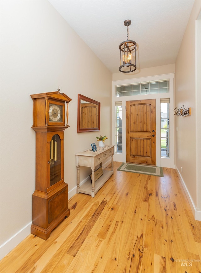 818 W Dallan Woods Way, Nampa, ID 83686 - foyer featuring light wood finished floors, healthy amount of natural light, and a chandelier