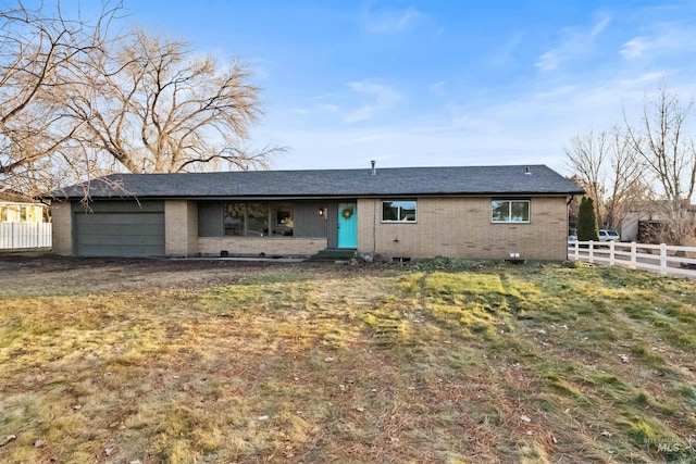 single story home featuring a garage and a front lawn