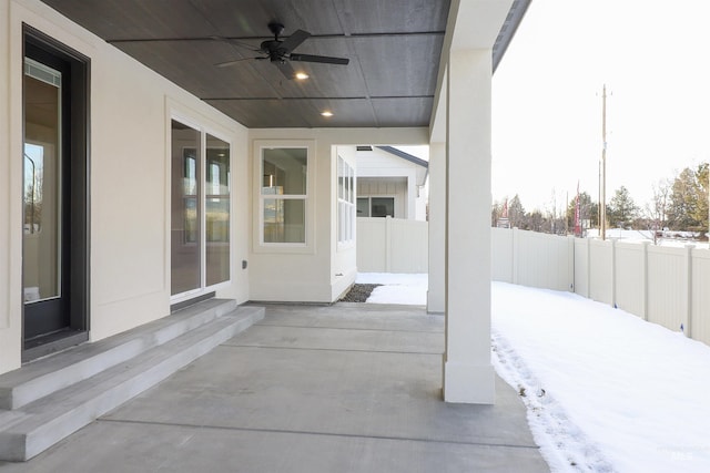 snow covered patio featuring ceiling fan