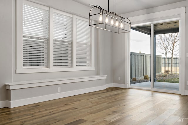 unfurnished dining area with wood-type flooring