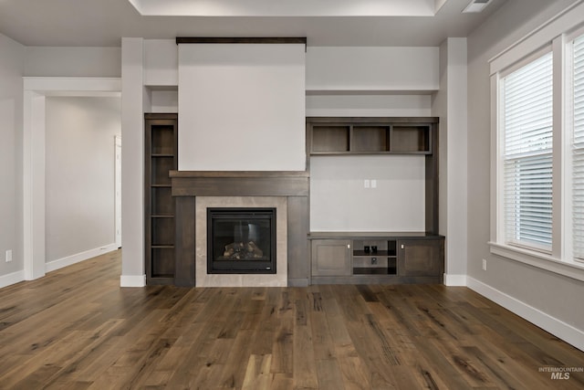 unfurnished living room featuring dark hardwood / wood-style floors and a fireplace