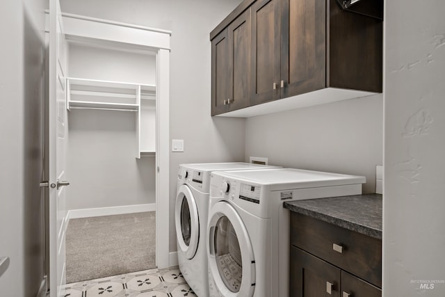 washroom featuring light colored carpet, cabinets, and washing machine and dryer