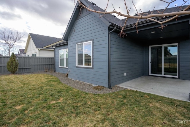 rear view of property with a yard and a patio