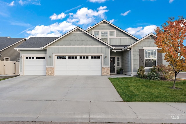 craftsman-style house featuring a front yard and a garage