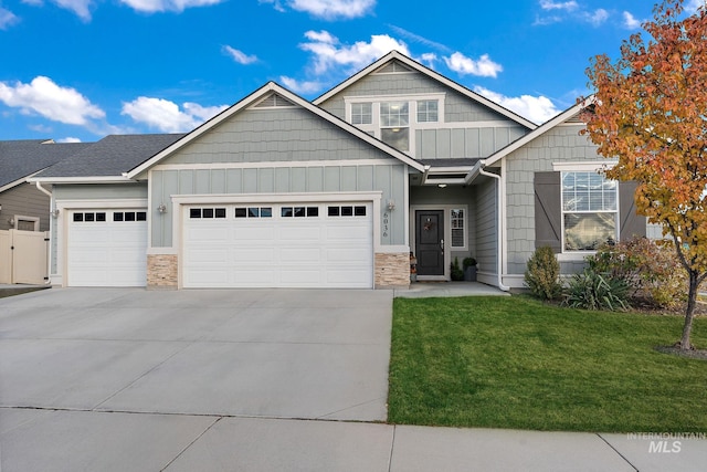 view of front of home with a front yard and a garage