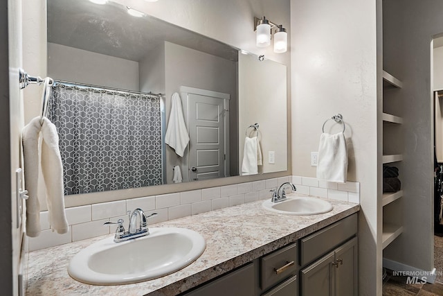 bathroom featuring vanity, built in features, and decorative backsplash