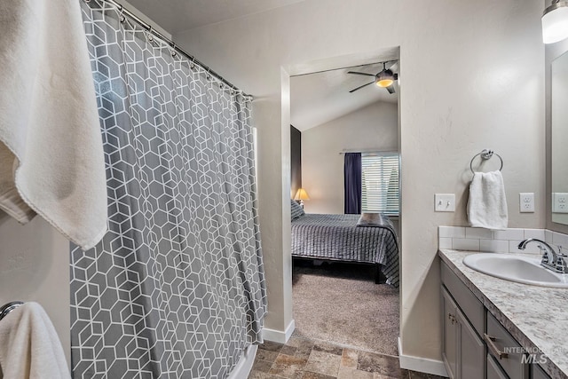 bathroom with vaulted ceiling, ceiling fan, and vanity