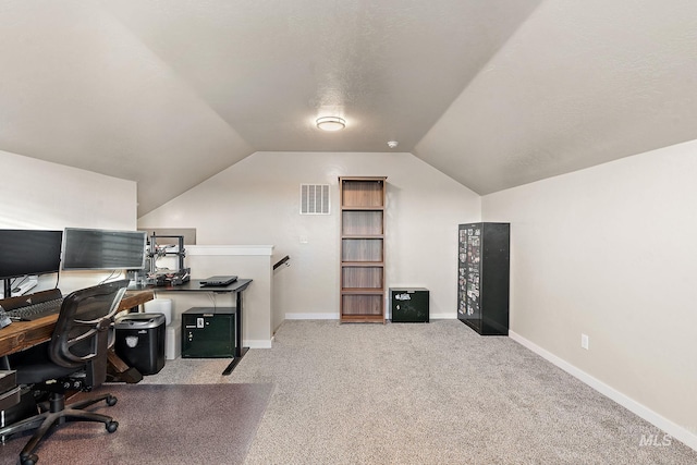 carpeted office space with lofted ceiling