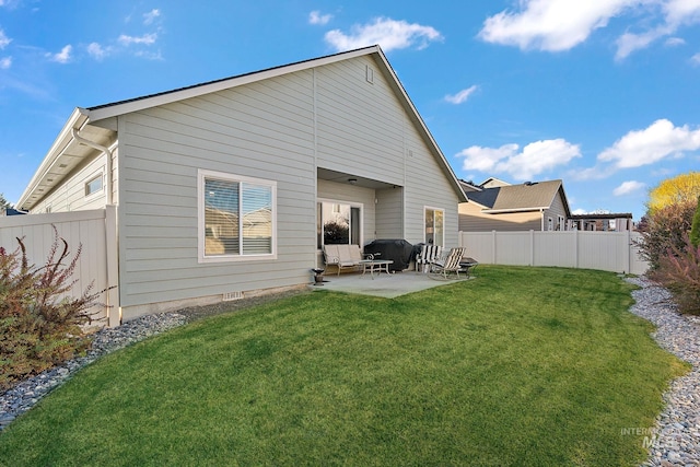 rear view of property featuring a patio area and a yard