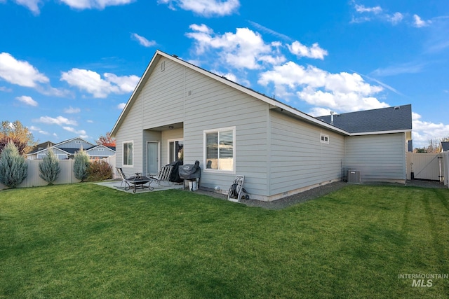 rear view of property with a yard and a patio area