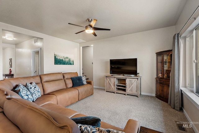 carpeted living room with ceiling fan